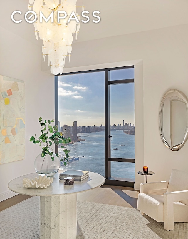 interior space featuring a view of city, an inviting chandelier, and wood finished floors