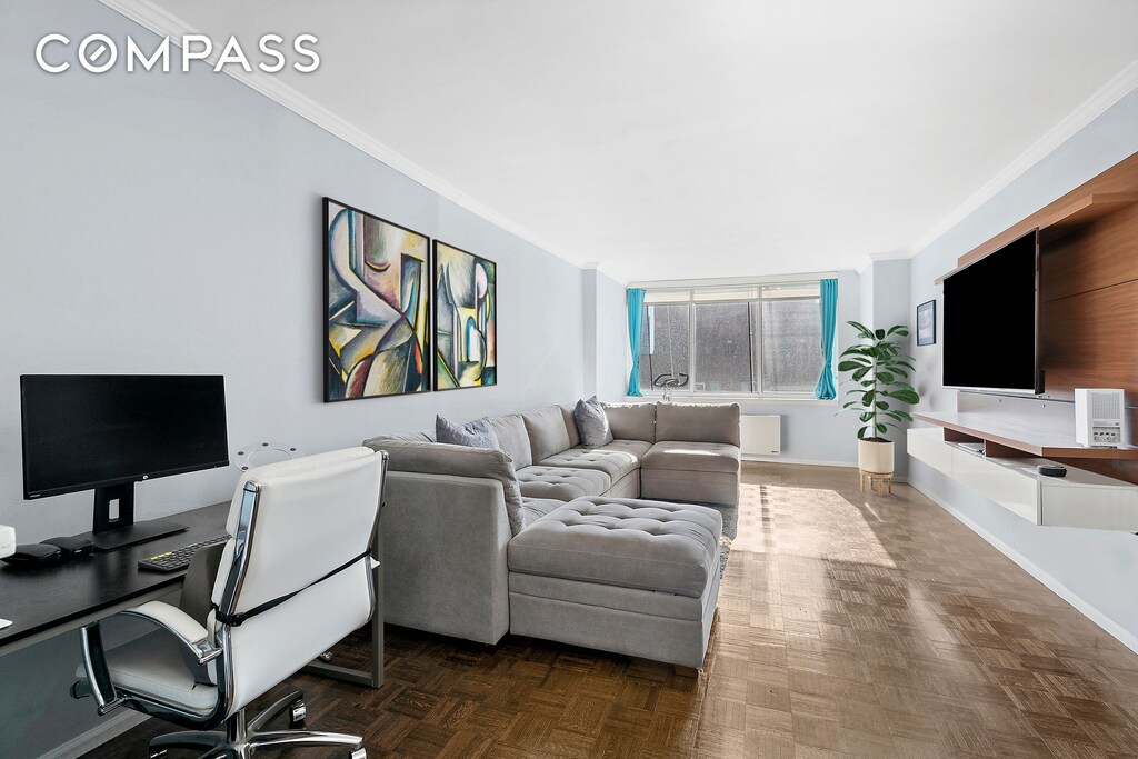 interior space featuring dark parquet flooring and ornamental molding