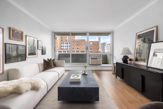 living area with crown molding, expansive windows, wood finished floors, and a city view