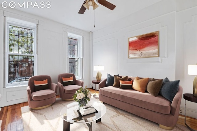 living room with ceiling fan and wood-type flooring