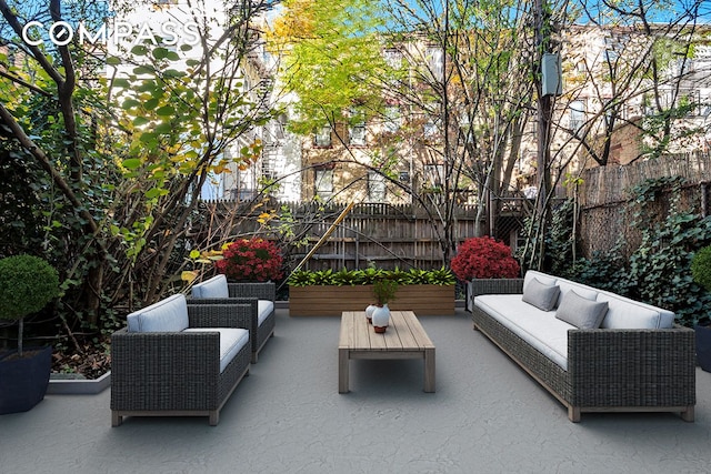 view of patio with outdoor lounge area and fence