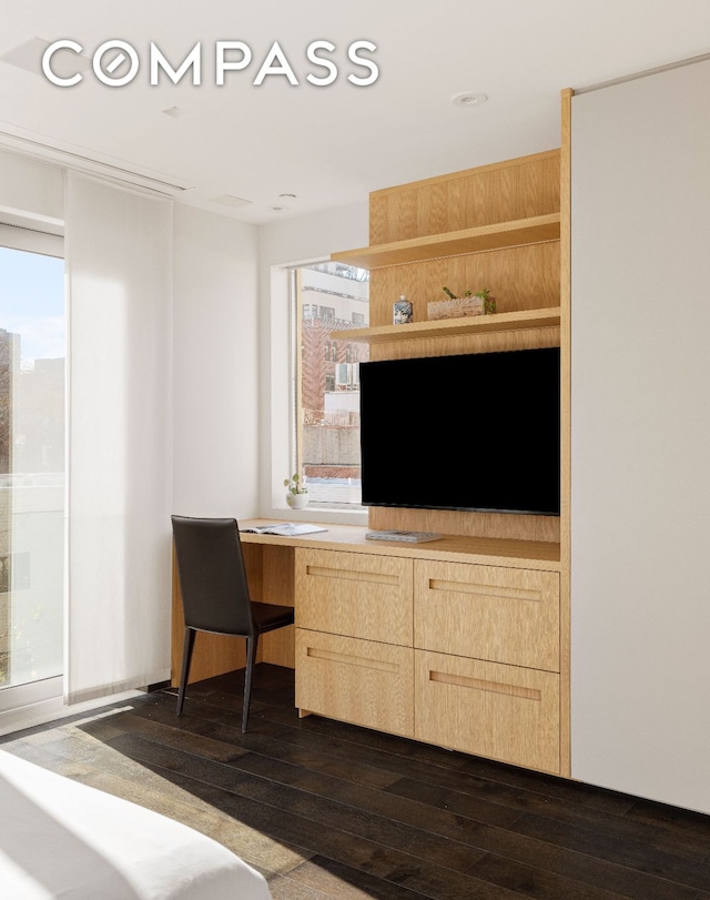 bedroom with multiple windows, dark wood finished floors, and recessed lighting