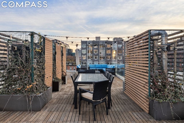 deck at dusk with outdoor lounge area