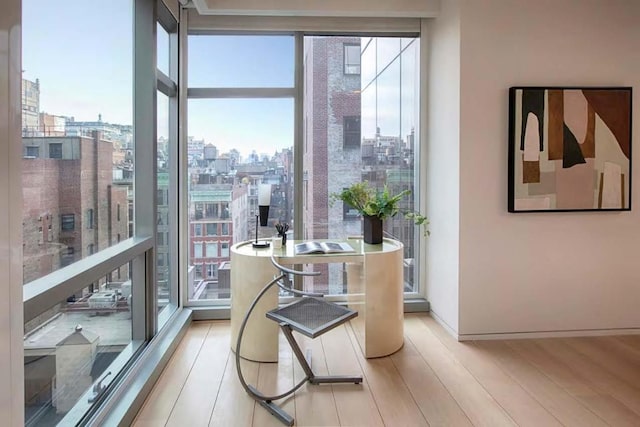 interior space with light wood-type flooring and floor to ceiling windows