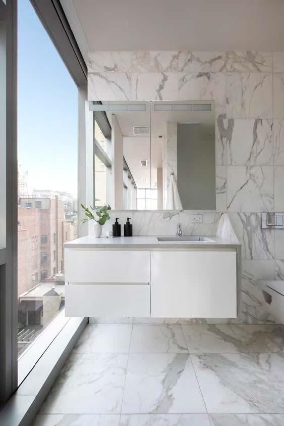 full bathroom featuring marble finish floor, double vanity, and a sink