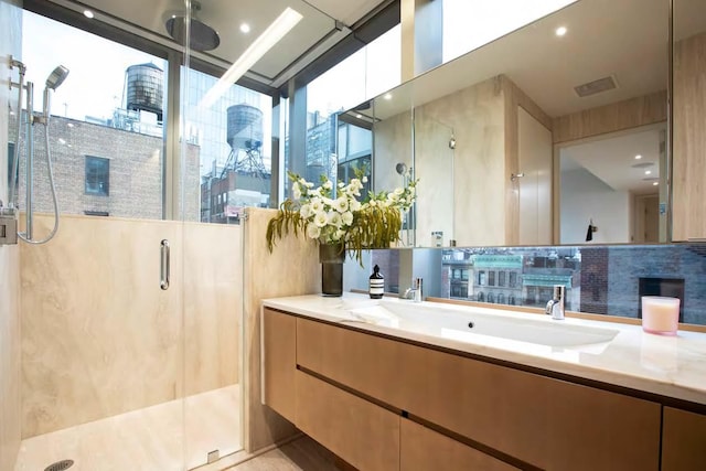 full bath with a stall shower, vanity, backsplash, and a city view