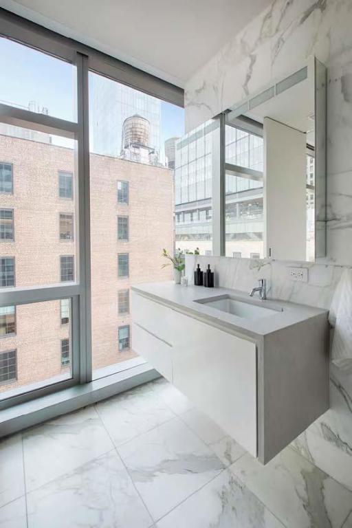 bathroom with sink and floor to ceiling windows