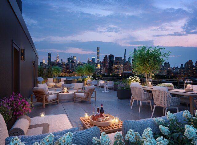 patio terrace at dusk with a city view and an outdoor living space with a fire pit