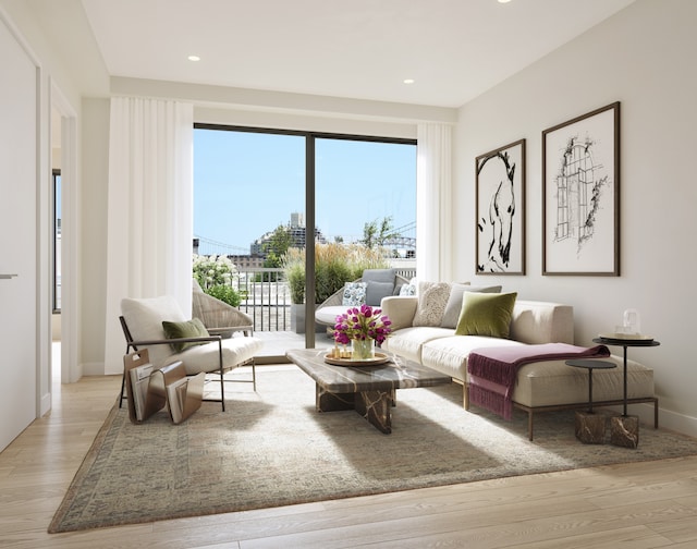 living area with baseboards, light wood-style flooring, and recessed lighting