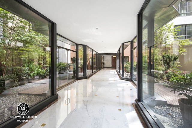 hallway featuring a wall of windows