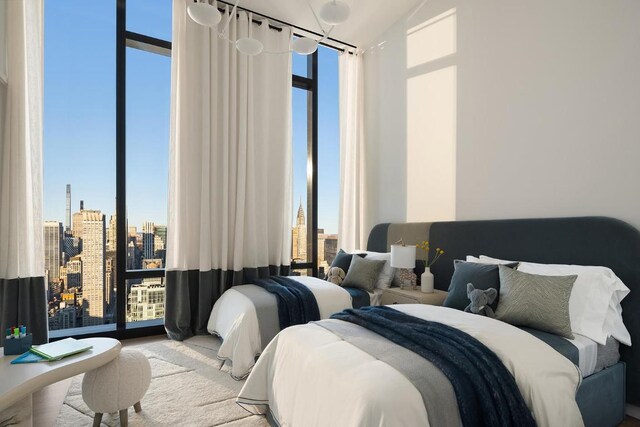 bedroom with vaulted ceiling and floor to ceiling windows