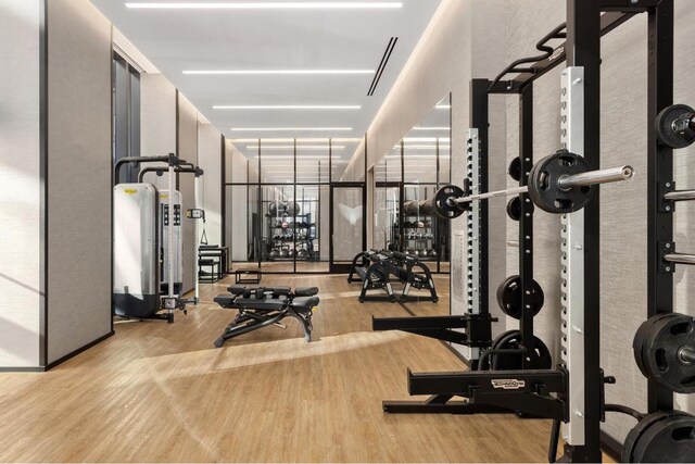 exercise room with light wood-type flooring