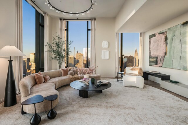 living room featuring rail lighting, a wealth of natural light, and floor to ceiling windows