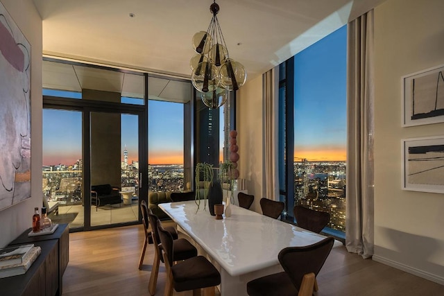 dining space with expansive windows and hardwood / wood-style flooring