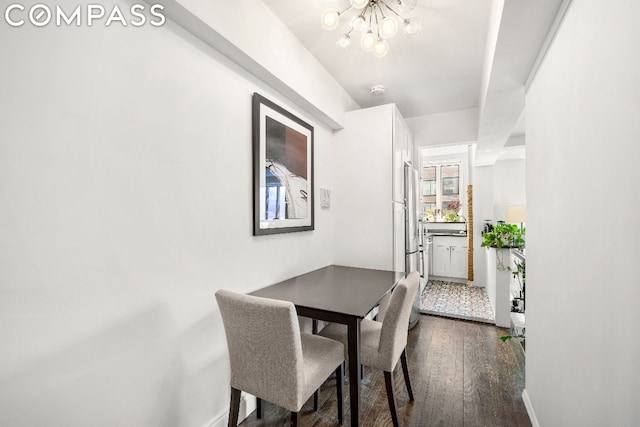 dining area featuring dark hardwood / wood-style floors and a chandelier