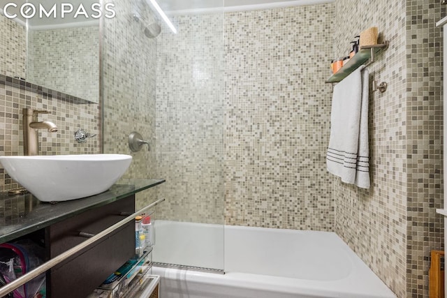 bathroom featuring vanity and enclosed tub / shower combo