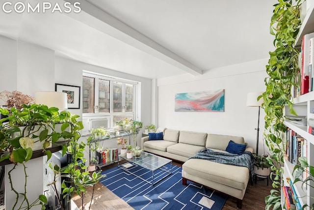 living room featuring beamed ceiling and dark wood-type flooring