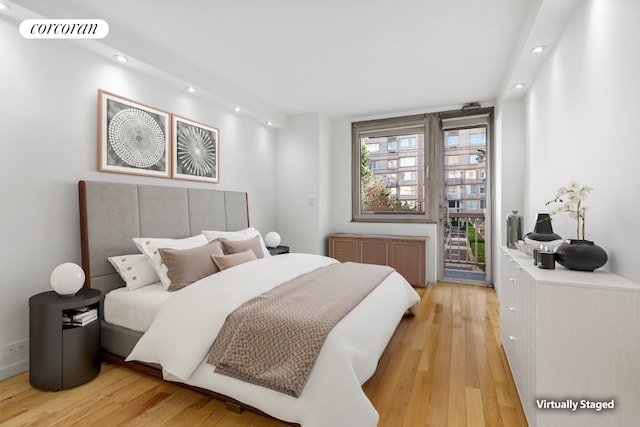 bedroom featuring visible vents, radiator, access to outside, light wood-style floors, and recessed lighting