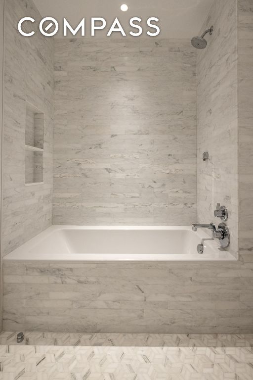 bathroom featuring a combined bath / shower with marble appearance