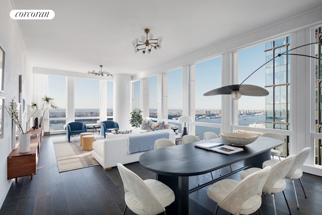 dining space featuring floor to ceiling windows, dark wood-type flooring, visible vents, and an inviting chandelier