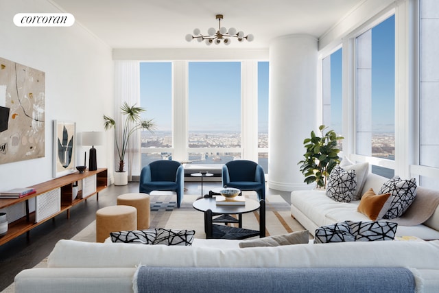 living area with a notable chandelier, visible vents, and wood finished floors