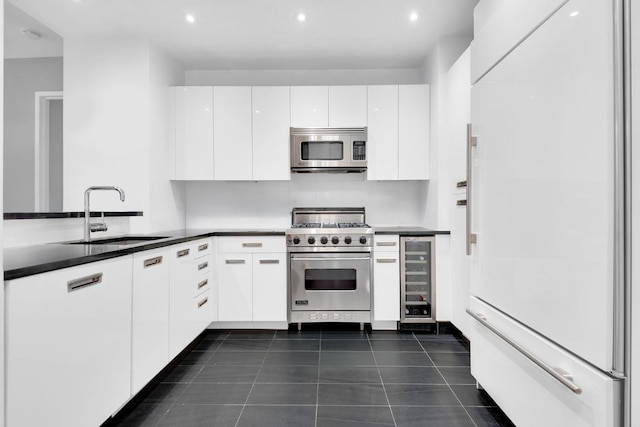 kitchen with white cabinetry, sink, premium appliances, and wine cooler