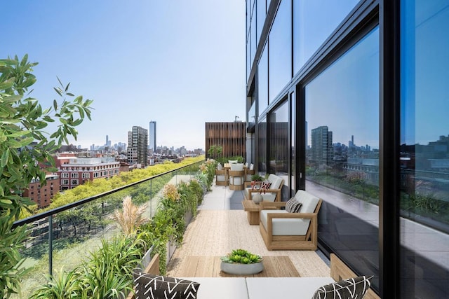 balcony with outdoor lounge area and a city view