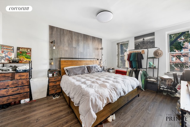 bedroom with dark hardwood / wood-style floors