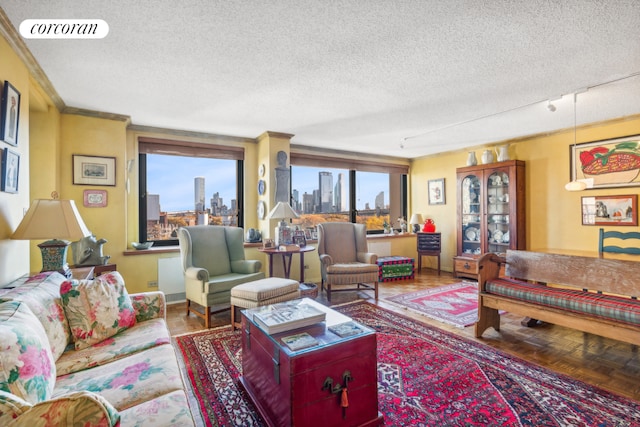 living room with a textured ceiling, a wealth of natural light, ornamental molding, and parquet flooring