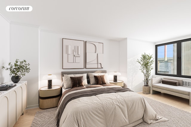 bedroom featuring ornamental molding and light hardwood / wood-style floors