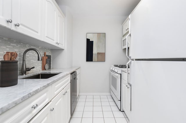 kitchen featuring a sink, white appliances, tasteful backsplash, and white cabinetry