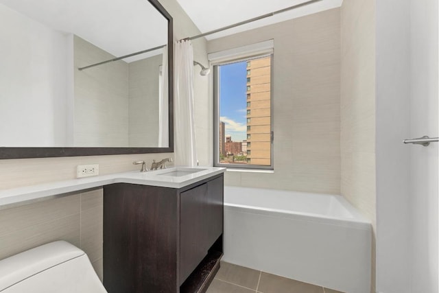 full bathroom featuring toilet, vanity, shower / tub combo, and tile patterned flooring