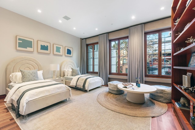 bedroom with wood finished floors and recessed lighting