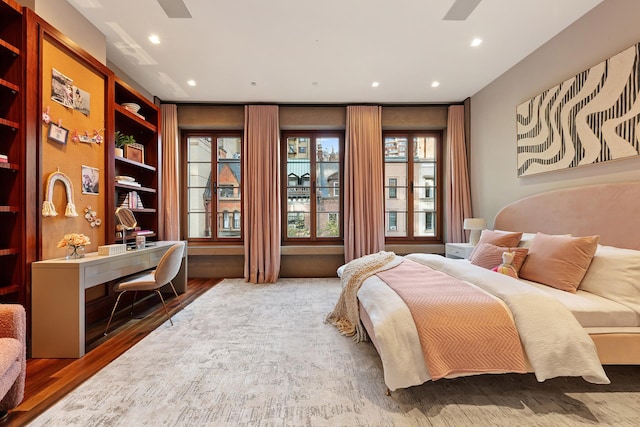 bedroom featuring multiple windows, recessed lighting, and wood finished floors