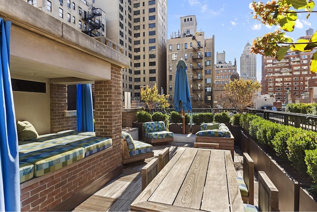 balcony with a view of city and an outdoor living space