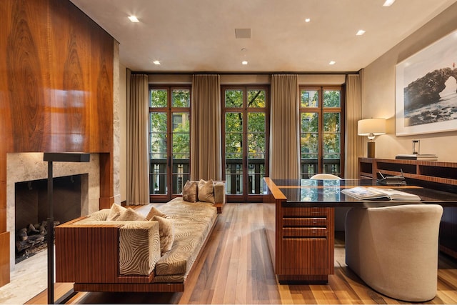 office space featuring recessed lighting, wood finished floors, and a fireplace