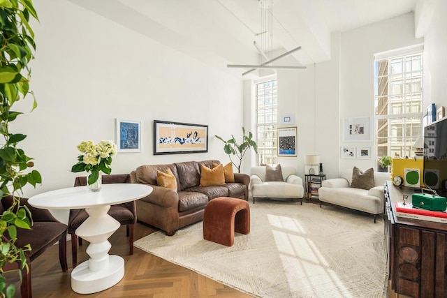 living room with a wealth of natural light and parquet flooring