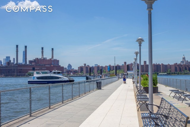 view of community featuring a city view and a water view