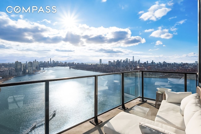 balcony featuring a city view and a water view