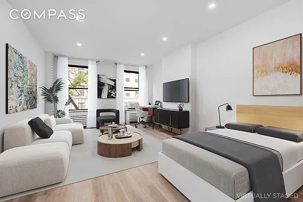 bedroom with recessed lighting and wood finished floors