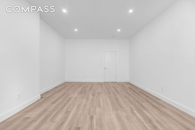 empty room featuring recessed lighting, baseboards, and light wood-style floors