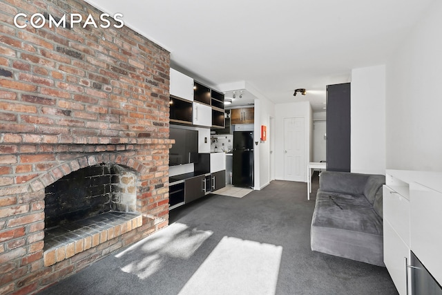 unfurnished living room with a fireplace and dark carpet