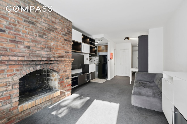314 W 56th St Unit 4E, New York City, NY 10019 - unfurnished living room with dark carpet and a fireplace