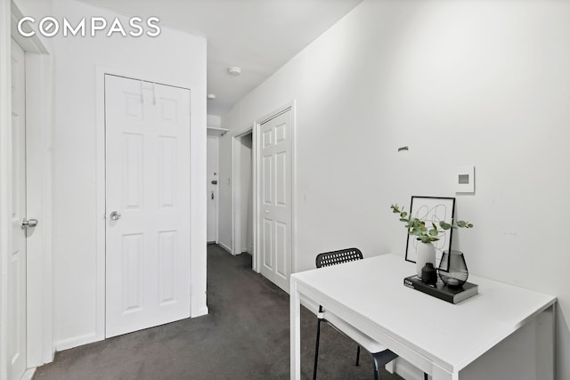 314 W 56th St Unit 4E, New York City, NY 10019 - office featuring dark colored carpet and baseboards