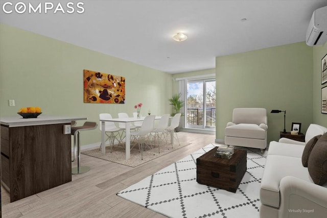 living room with a wall mounted AC and light wood-type flooring