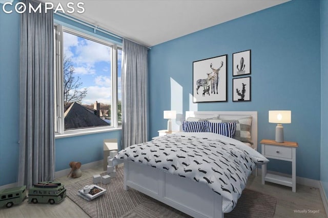 bedroom with wood-type flooring