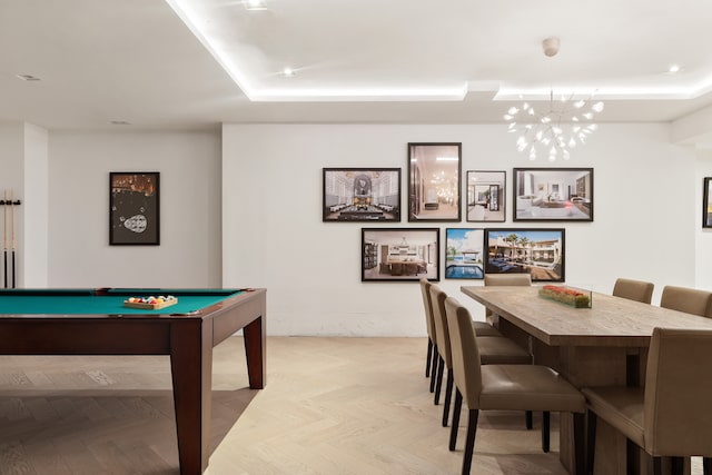 playroom with billiards, a chandelier, and a raised ceiling