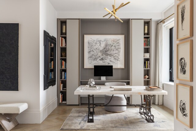 home office featuring an inviting chandelier