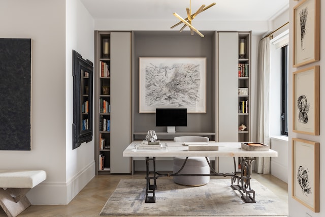 home office featuring a chandelier and baseboards