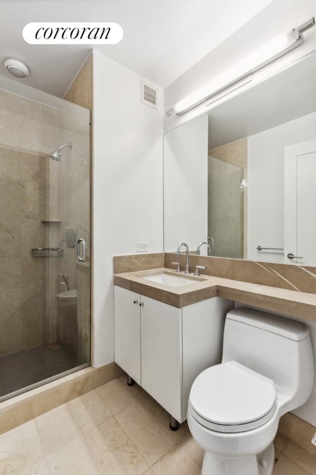 bathroom with toilet, a stall shower, visible vents, and vanity